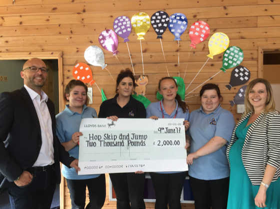 SH&P holding a cheque at Woodstock School